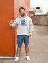 Featuring a stunning graphic of a majestic snowy owl in flight, set against the glowing northern lights, this hoodie embodies the freedom and grace of the province’s untamed wilderness.